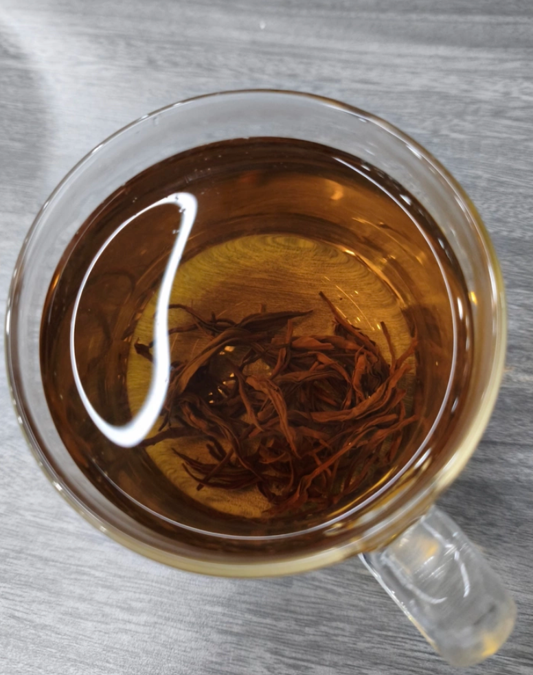 Brewed Keemun black tea in a glass cup