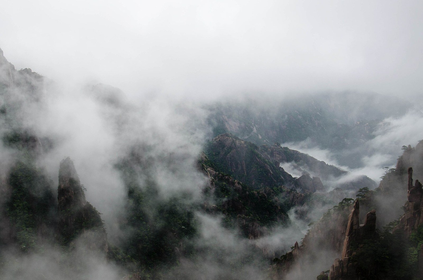 Dense mist drifting over the granite peaks and pine-covered cliffs of Huangshan (Yellow Mountain) in Anhui