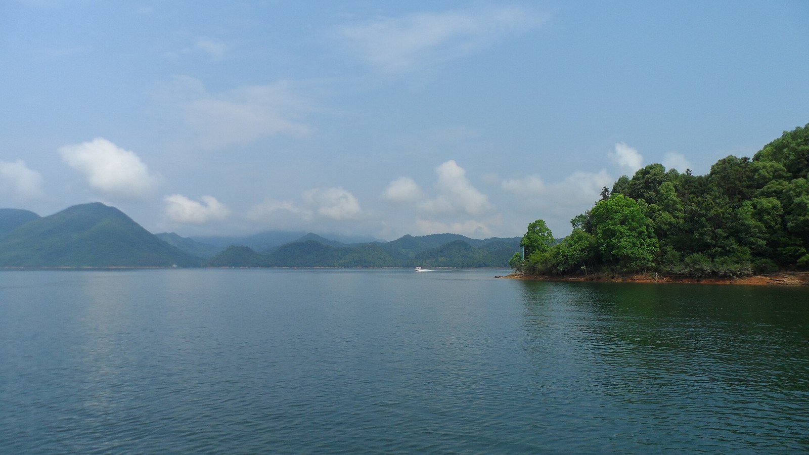 Taiping Lake in Huangshan District, Anhui, with forested hills along the shore