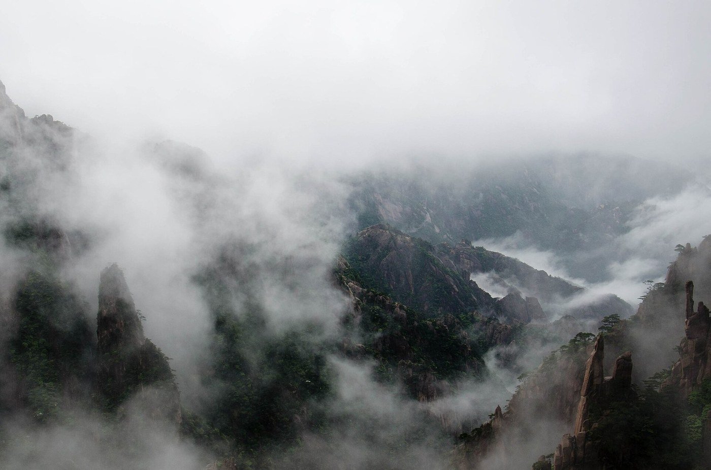 Dense mist drifting over the granite peaks and pine-covered cliffs of Huangshan (Yellow Mountain) in Anhui